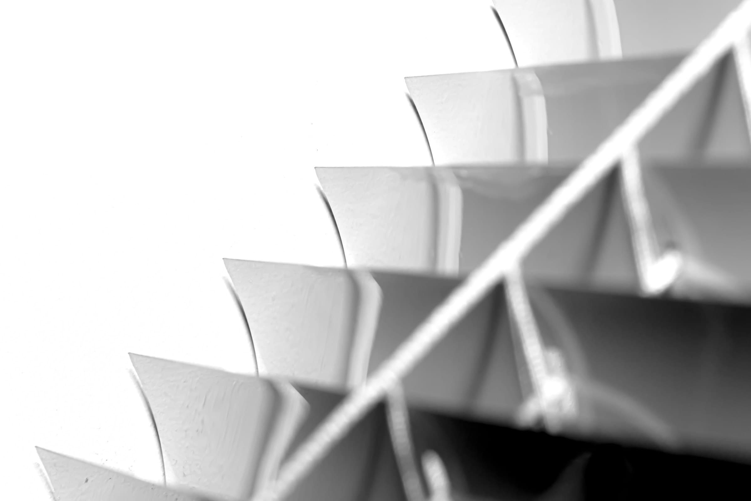 Machined cooling fins in raked light, shot against white