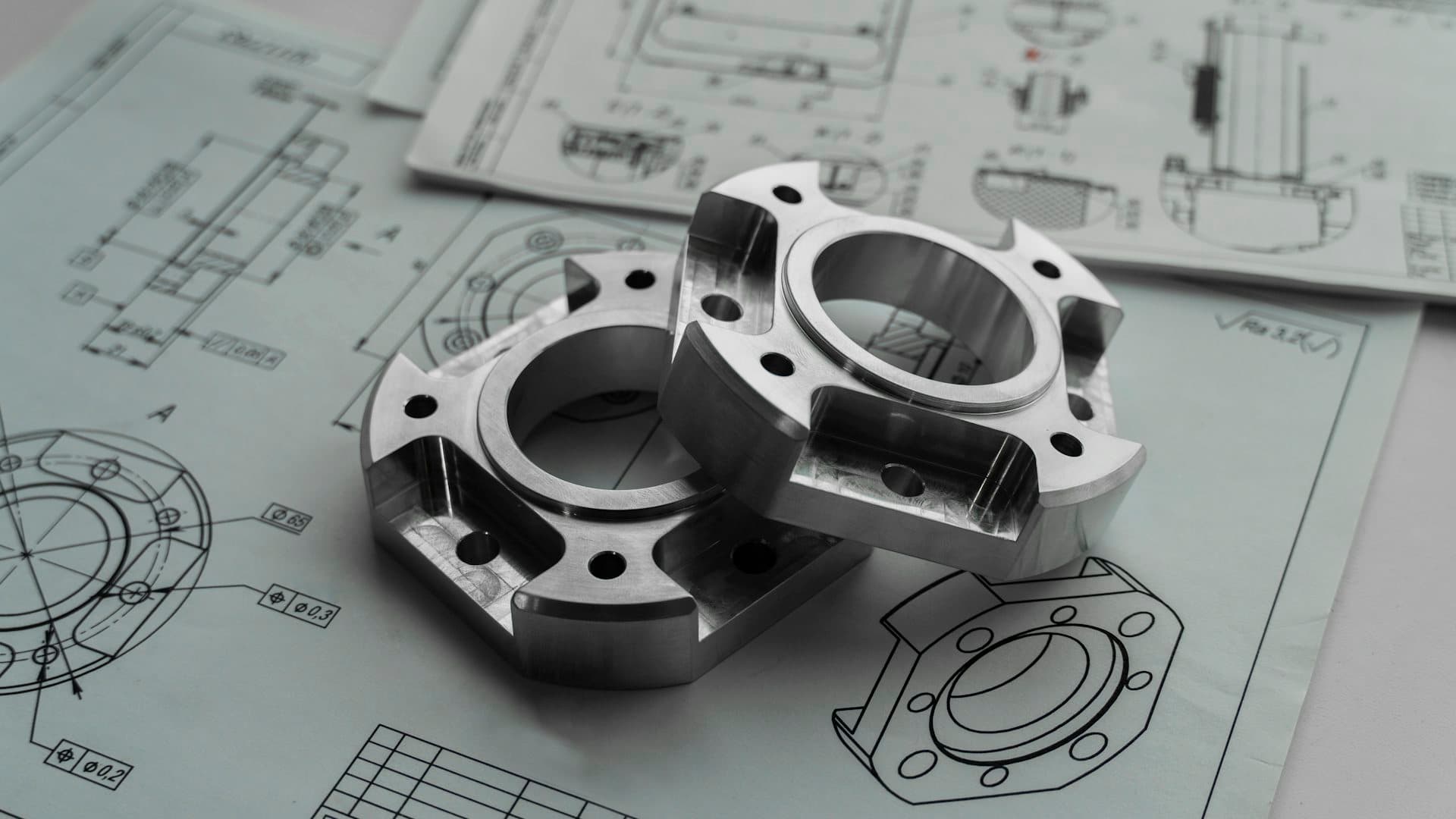 Machined pipe flanges stacked in raking light